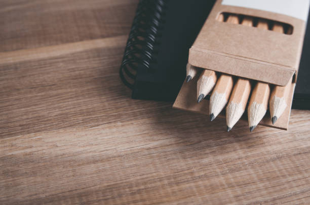 istock Pencils and notebook on a wooden table. Template for text or design 1070127536
