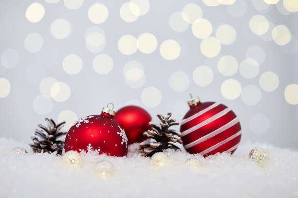 istock Christmas red baubles on snow 1070127586