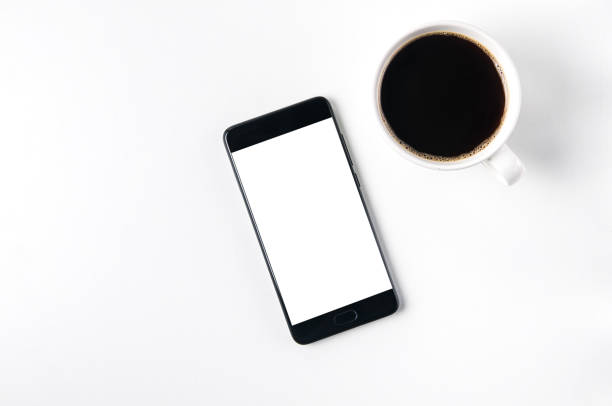 istock A Cup of coffee and a smartphone on a light background. Template for design or application 1070128114