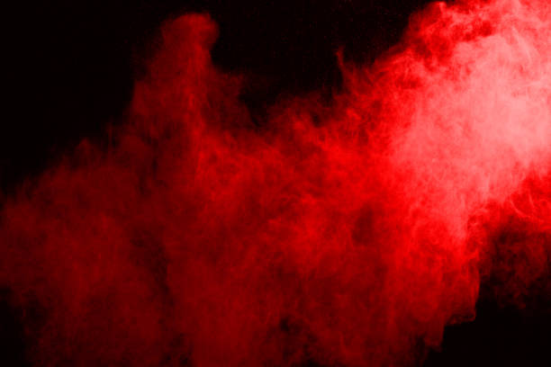 istock abstract red powder explosion on black background.abstract red powder splatted on black background. Freeze motion of red powder exploding. 1070133016