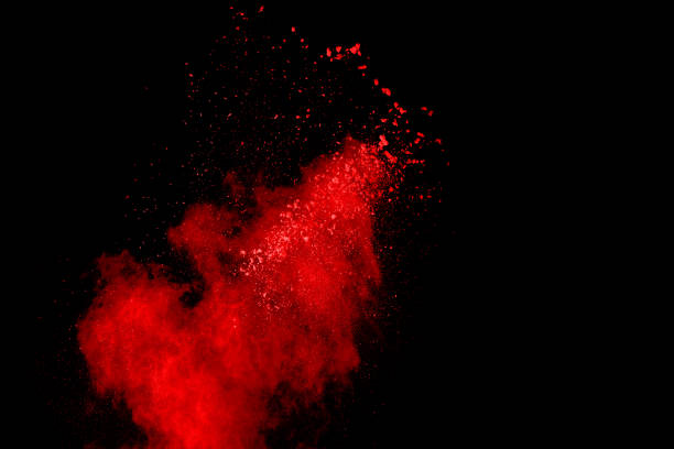 istock abstract red powder explosion on black background.abstract red powder splatted on black background. Freeze motion of red powder exploding. 1070133216