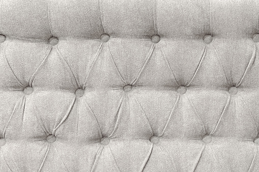 Upholstery background - tufted fabric of bed headboard