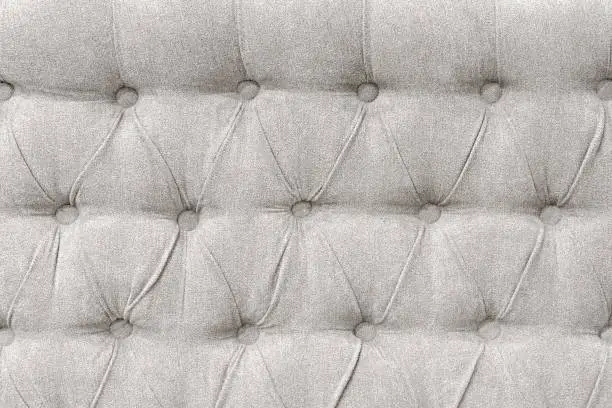 Upholstery background - tufted fabric of bed headboard