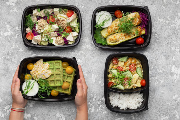 istock Plastic containers with delicious food on gray background 1070135074