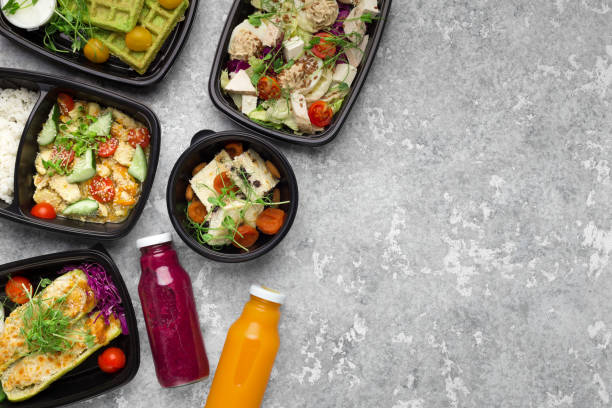 istock Plastic containers with delicious food on gray background 1070135158