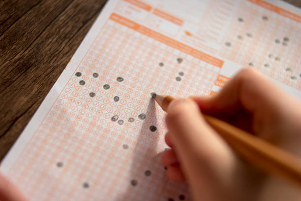 istock Hand fill in Exam carbon paper computer sheet and pencil 1070139074