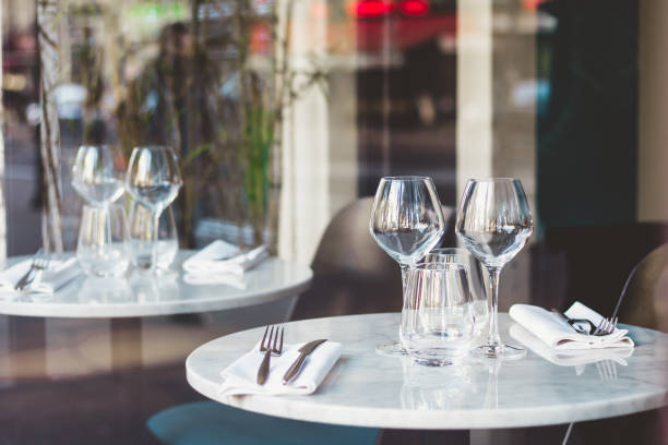 istock Table setting in a French restaurant for two. View through a window from a street. 1070142442