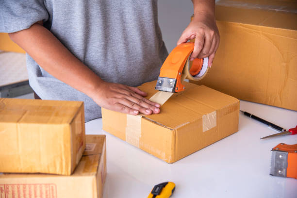 istock The staff is using the tape to pack the package goods to the customer. 1070143196