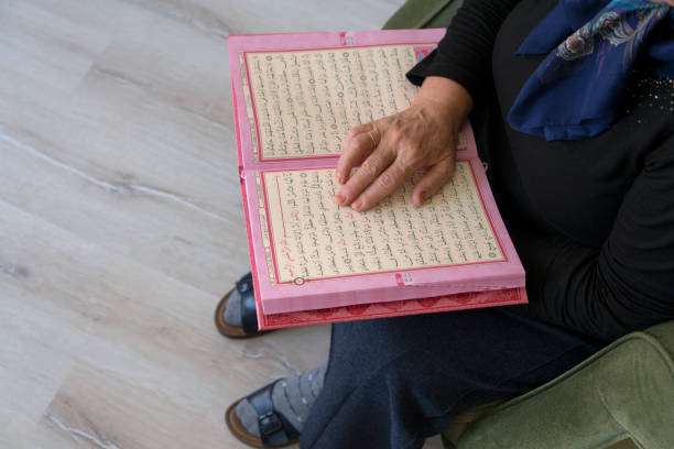 muslim woman reading holy koran - cairo mosque egypt inside of imagens e fotografias de stock