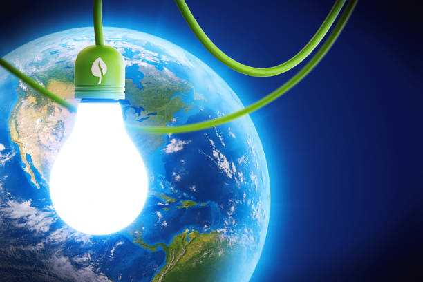 Green energy light bulb hanging in front of earth globe
