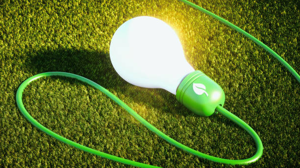 istock Green energy light bulb on artificial grass ground on sunny day 1070150476