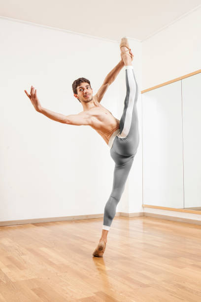 istock Young beautiful male  ballett dancer posing in studio 1070152992