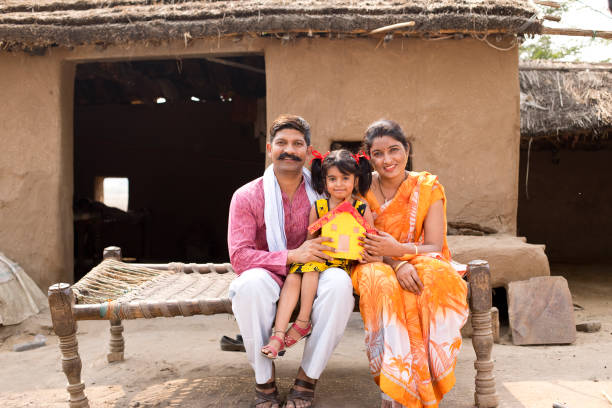 istock Indian family holding dream house model 1070153656
