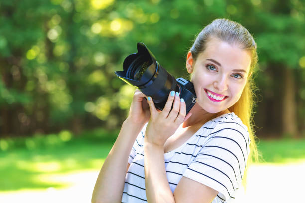 istock Young woman with a professional camera 1070154512