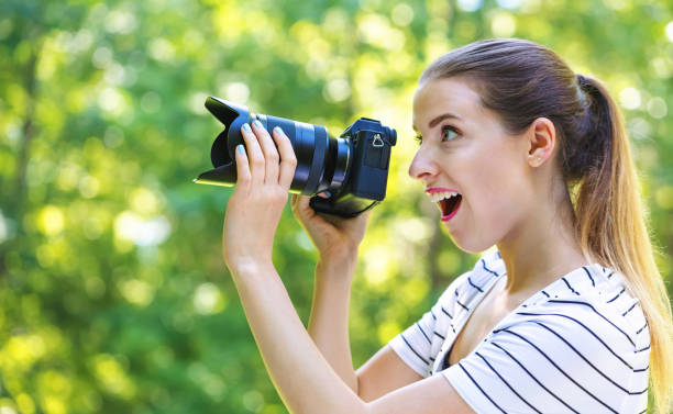istock Young woman with a professional camera 1070154520