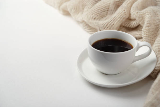 istock A Cup of fragrant black coffee and a textured wool blanket. Warm tone 1070156328