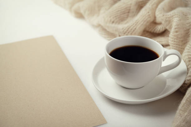 istock A Cup of fragrant black coffee and a textured wool blanket. Warm tone 1070156416