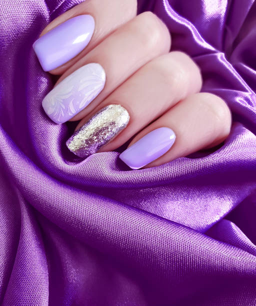 istock female hand colored manicure on silk fabric 1070156606
