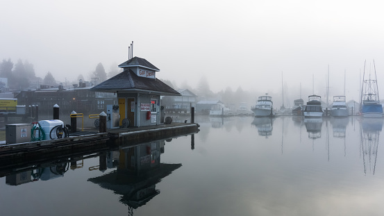Serene Photo of a winter harbor and smooth as glass water with a gas / petrol refilling station