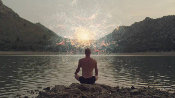istock Cosmic energy in front of Meditating man. 1070156804