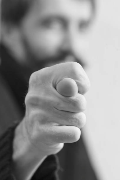 istock A man shows a fig gesture his face is out of focus. 1070157370