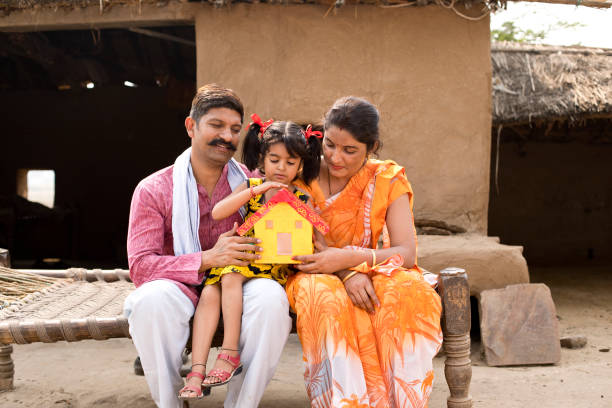 istock Indian family holding dream house model 1070159036