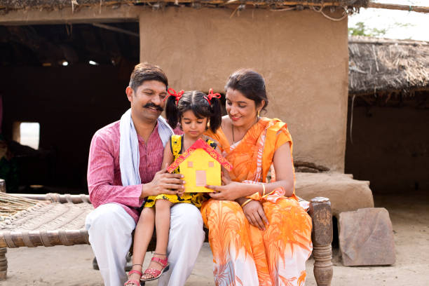 istock Indian family holding dream house model 1070159090