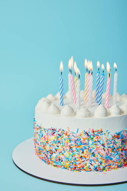 istock Birthday cake with lighting candles on blue background 1070159158