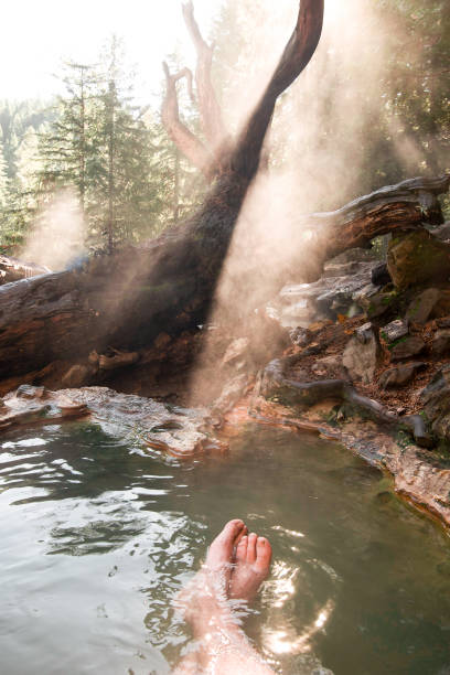 istock Two feet visible beneath the warm hot spring waters surrounded by mist in Oregon 1070161842
