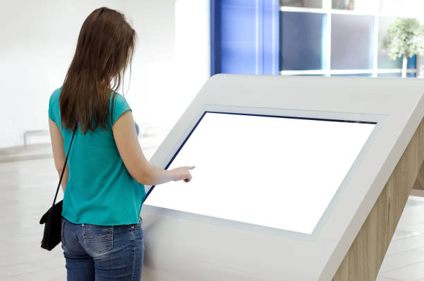 Woman. Woman is using a blank touch screen of interactive information stand in the supermarket. interactivity stock pictures, royalty-free photos & images