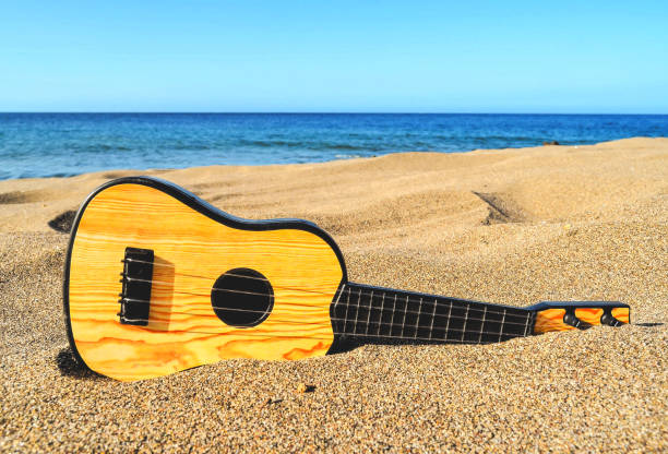 istock Guitar on the Sand Beach 1070163100