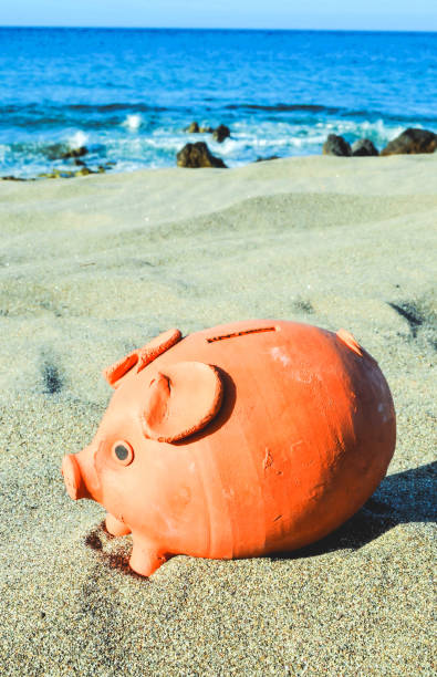 istock Piggy Bank on the Sand Beach 1070163122