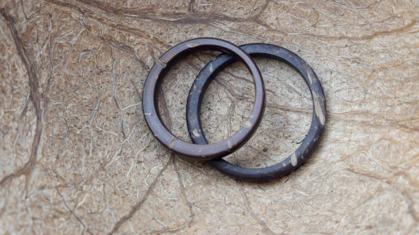 istock His and Hers handmade coconut rings with coconut interior background. Artisan wedding ring bands. Love and union concept 1070174390