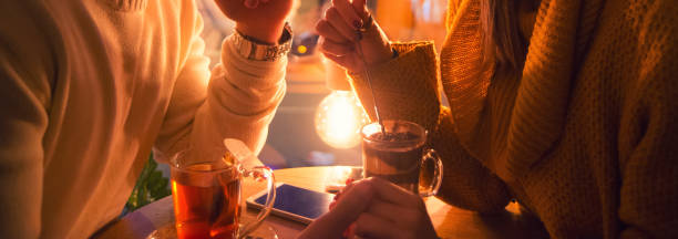 Couple holding hands in the coffee bar