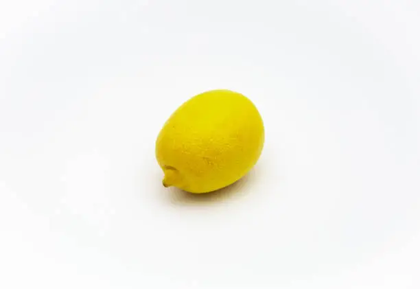 One lemon isolated on white background. Tropical fruit. Top view