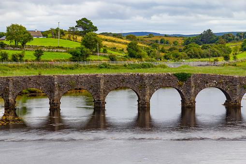 River, stone bridge and farms in background, Great Western Greenway trail, Ireland