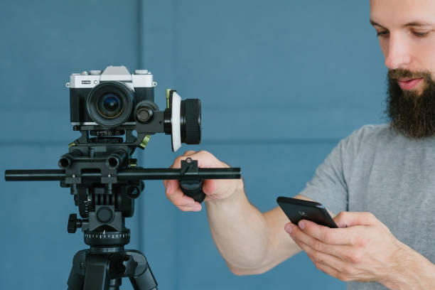 istock video shooting man camera equipment phone check 1070183382