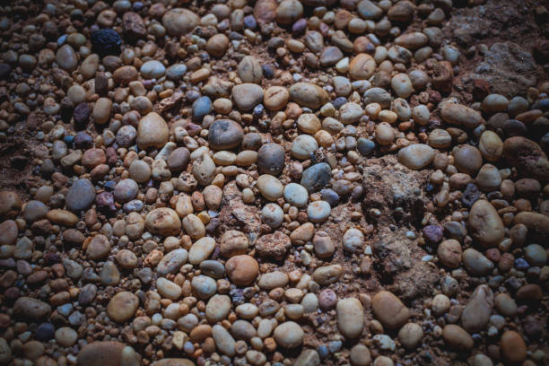 Sea stones background. Abstract texture and background made with small pebbles at the shore. Rocks abstract texture for design.