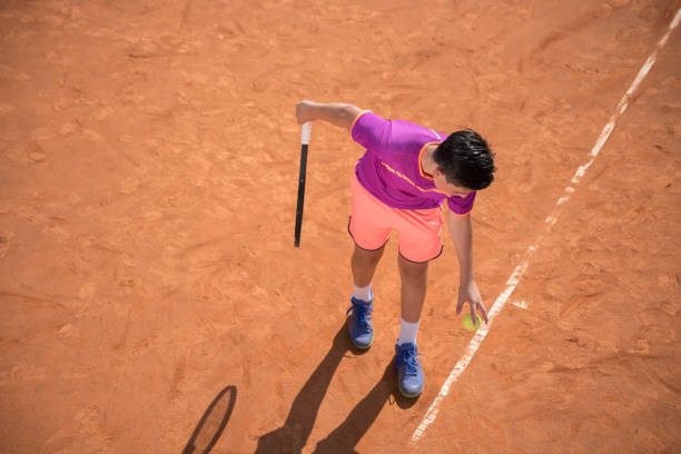 istock Young tennis player prepares for serving the ball 1070185888