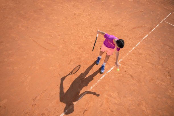 istock Young tennis player prepares for serving the ball 1070187156