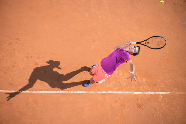 istock Young tennis player serving the ball 1070187256