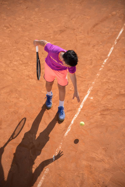 istock Young tennis player prepares for serving the ball 1070187394