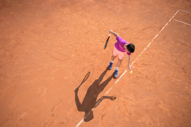 istock Young tennis player prepares for serving the ball 1070187600