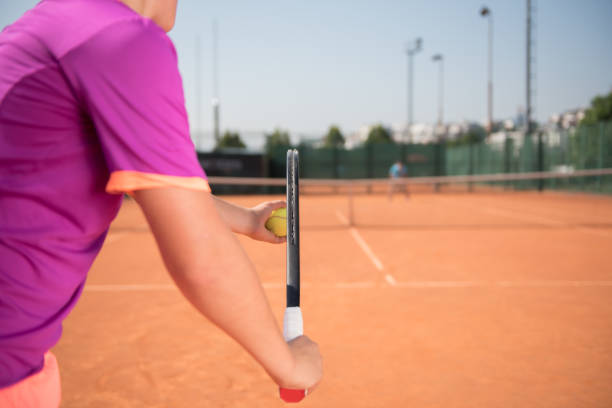 istock Young tennis player prepares for serving the ball 1070187628