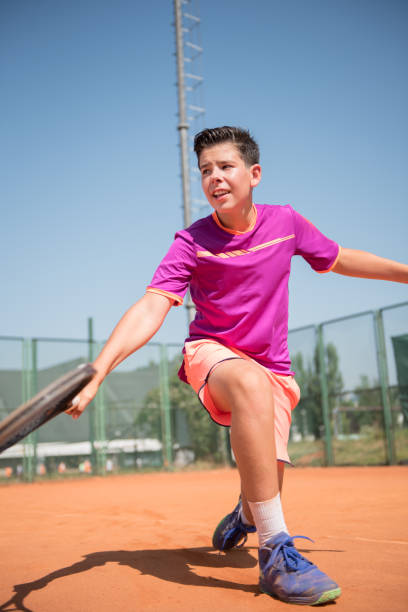 istock Young tennis player playing backhand and glide 1070187674
