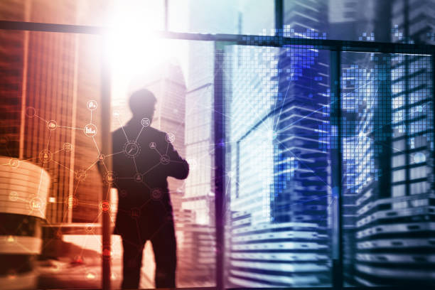 istock Double exposure mixed media. Diagrams, icons and relations structure on hologram screen. Business people and modern city on background. 1070187894