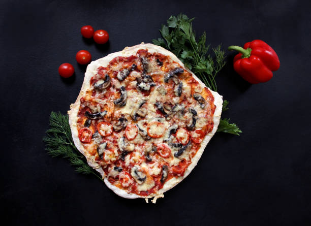 istock tasty pizza with mushrooms, tomatoes 1070188758