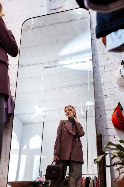 istock Beaming beautiful blonde-haired woman smiling looking into mirror 1070191312