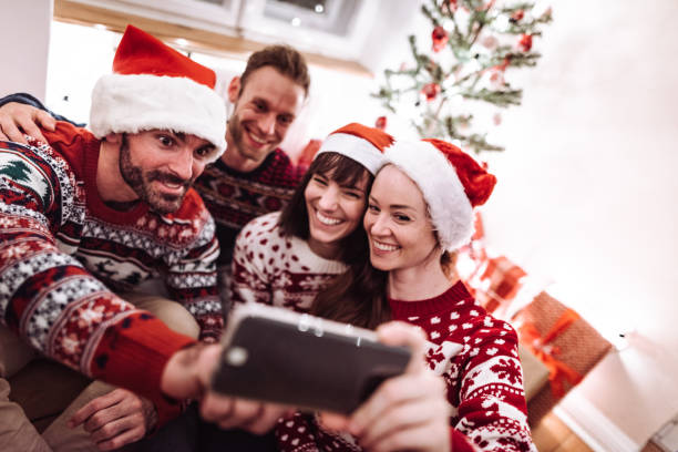 istock friends using smartphones at christmas 1070197430