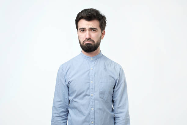 istock Guy looking unsatisfied and tired. Man is unhappy and thinks about some fun while working 1070197870